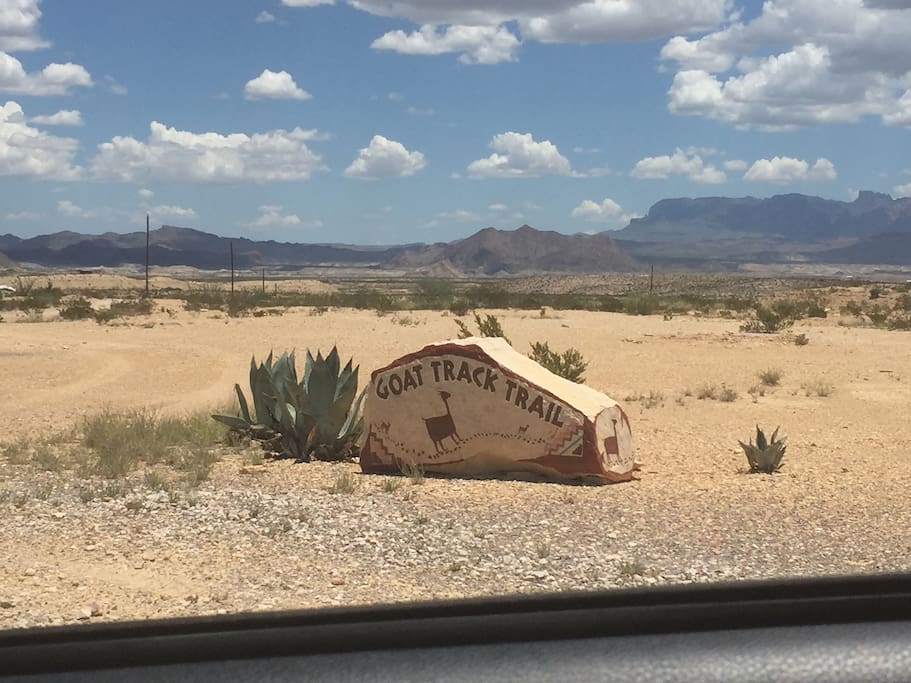 Road is marked with a rock painted "Goat Track Trail"