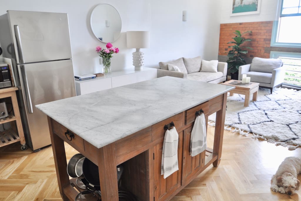 Island bench with marble countertop is the perfect spot for your morning coffee