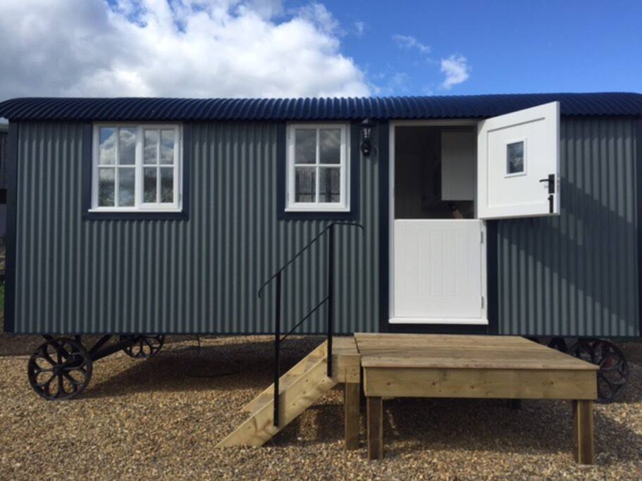 Our wonderful shepherds hut set in its own grounds with only the birds, lambs and calves for company! Situated within its own garden with a patio set so you can watch the sun go down with just the birds to listen to.