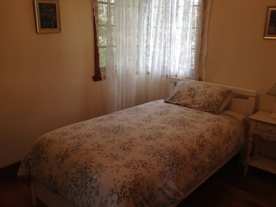 King single bedroom with ceiling fan.