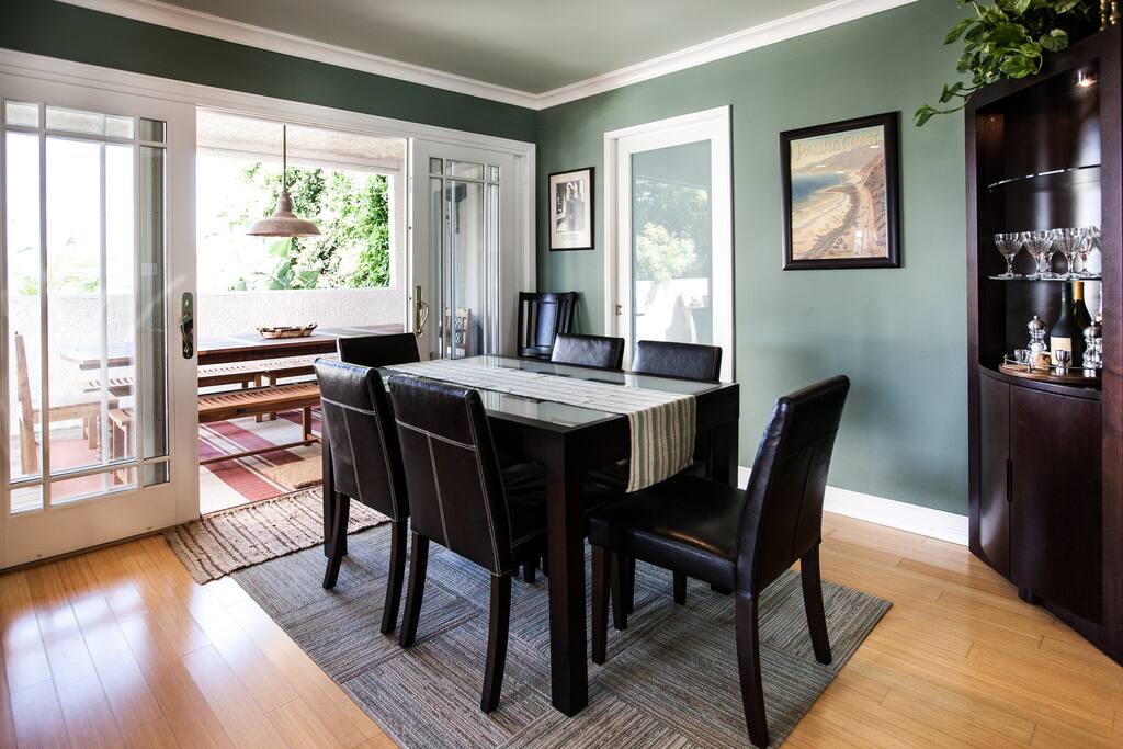 Main house dining room opens to spacious outdoor dining table and deck.