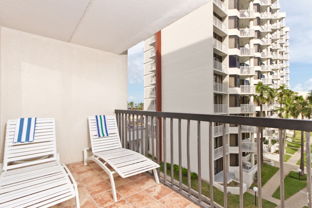 Lounge chairs on our private balcony pool & beach view