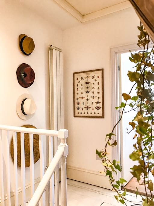 White painted stairs lead up from the flat entrance. The bathroom is on the lower level, the bedroom and kitchen are up some steps.