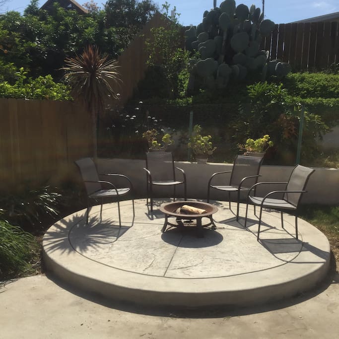Fire-pit and seating area in the fenced backyard