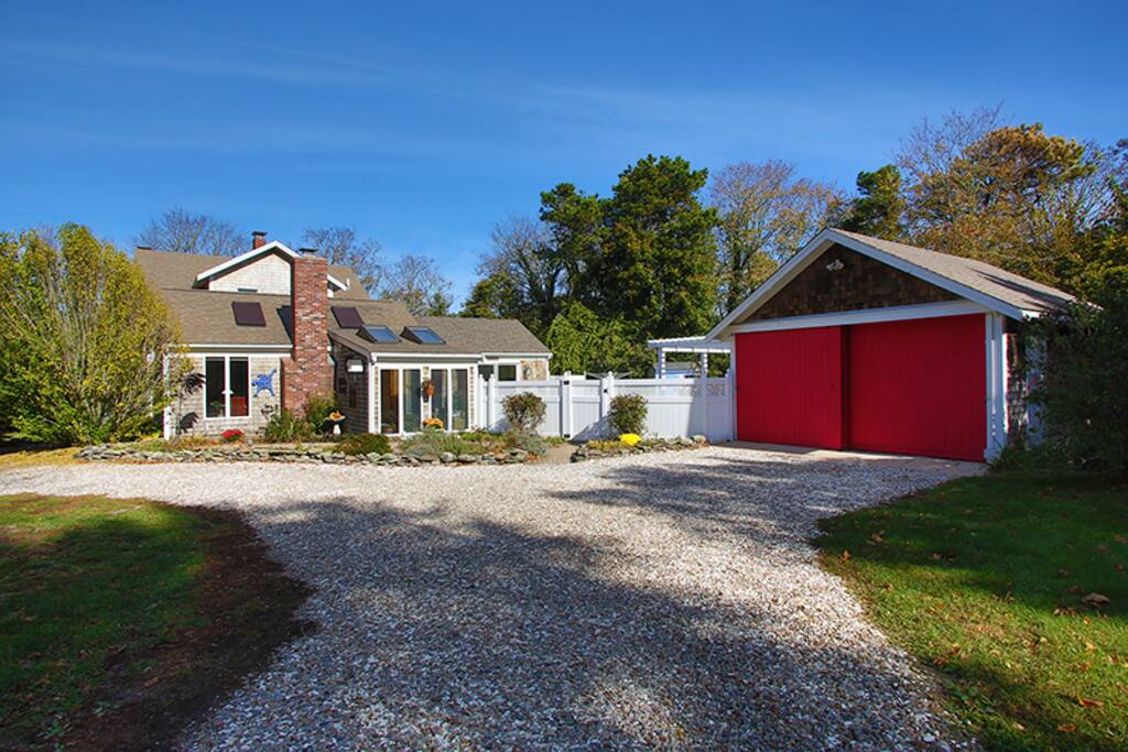 Backside of house, including gate to the in-ground heated pool and outdoor bar.
