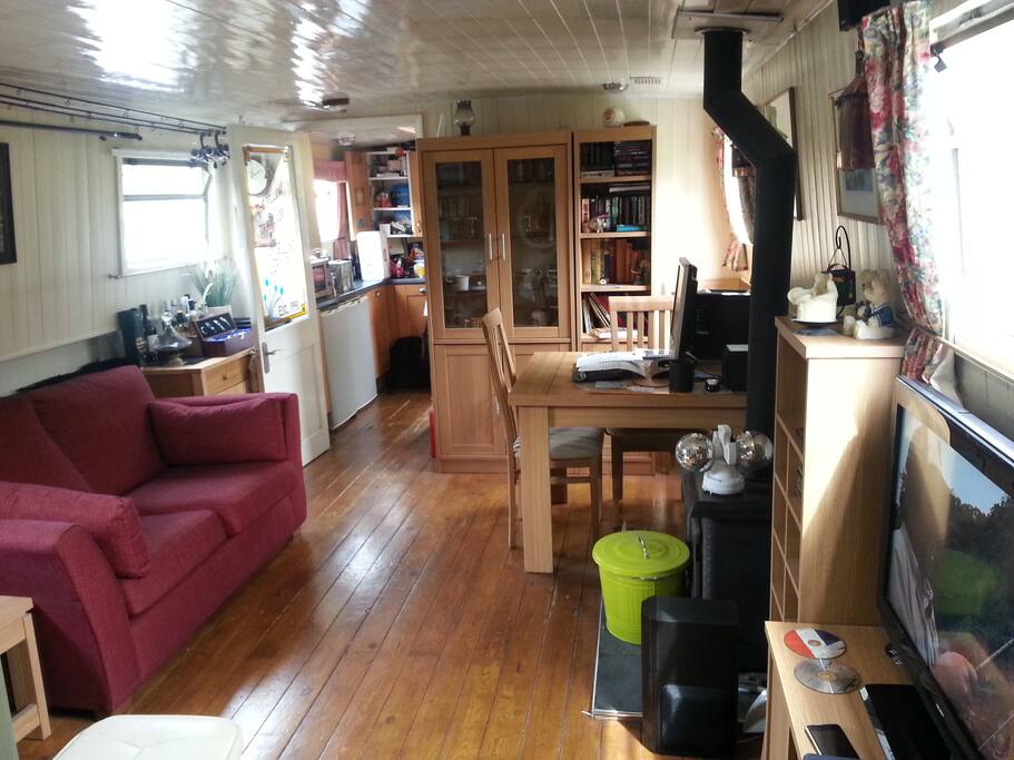 The Time Machine living room with multi-fuel stove and SMART TV.