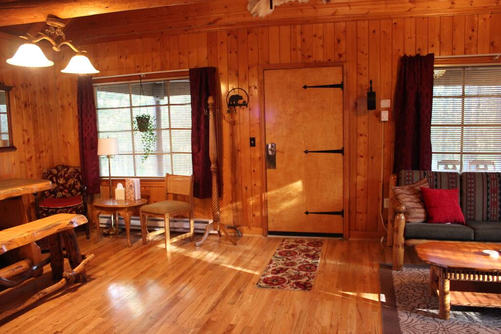 The front door, with the living room on the right, and dining area on the left.