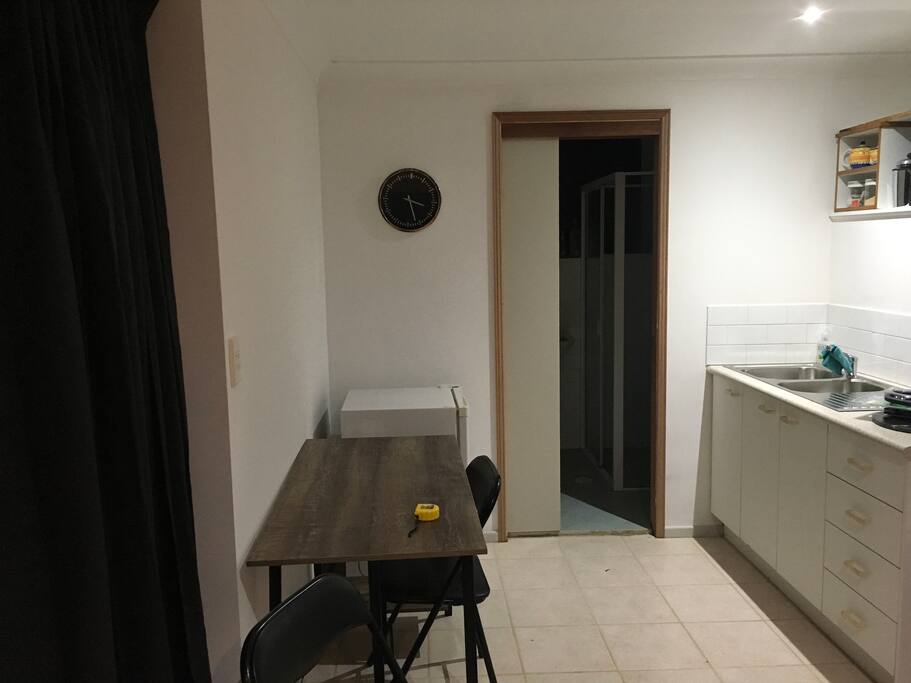 Table fridge next to bathroom