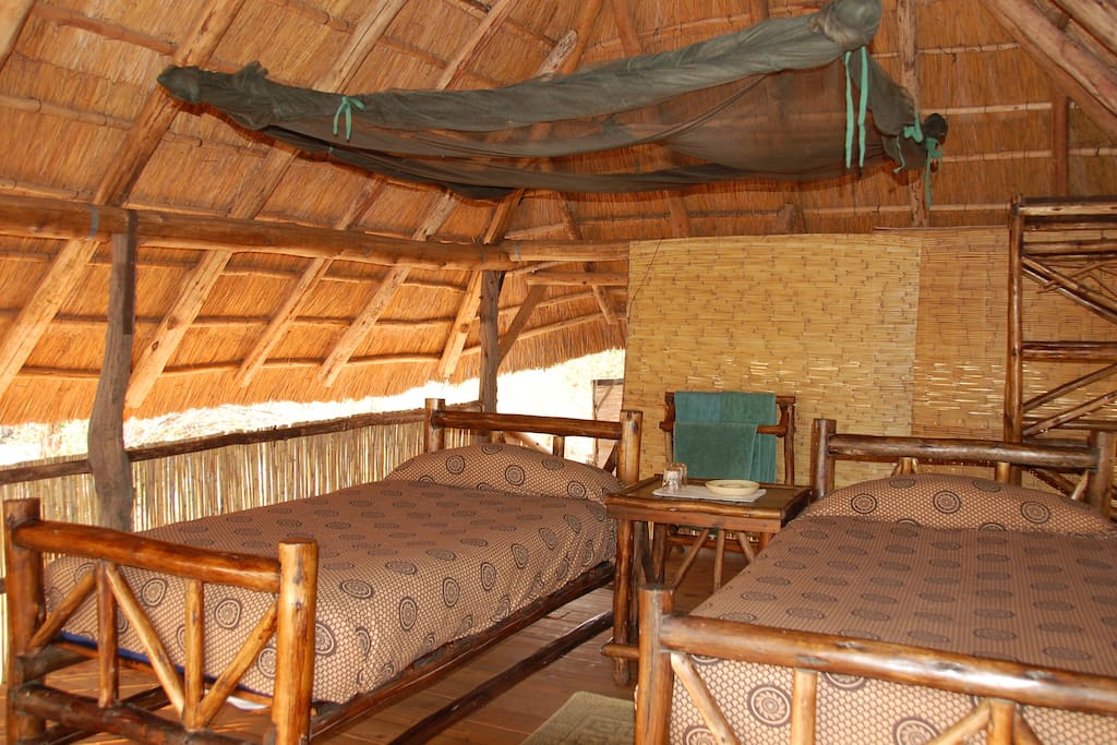 Jumbo walk-in mosquito nets which are lowered at night.