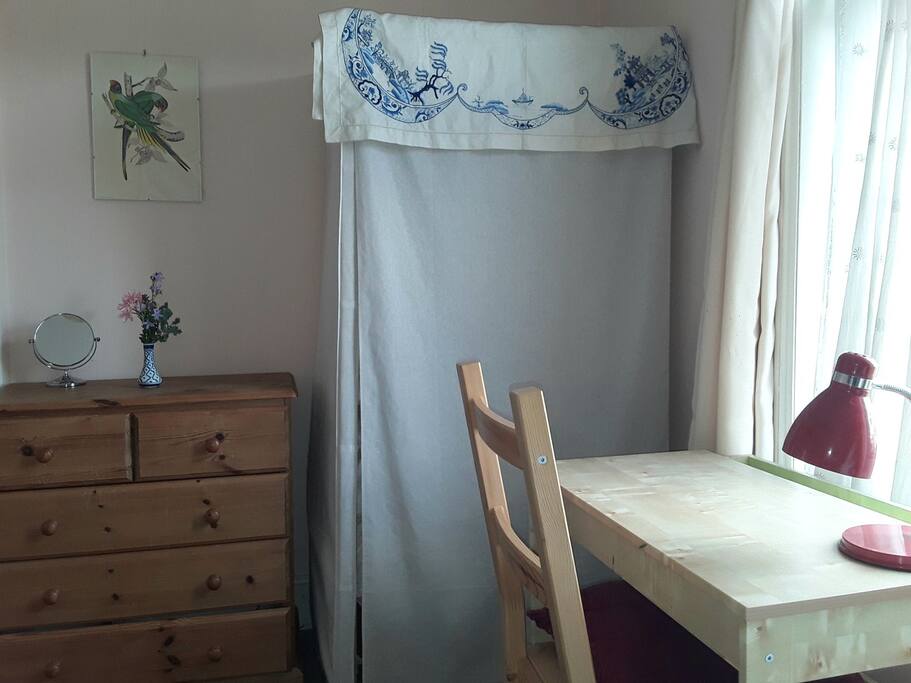 A nice light desk space and wardrobe for hanging clothes