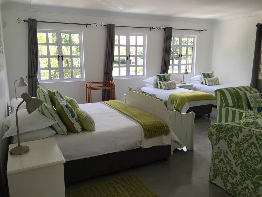 King sized bed and 2 singles in open plan area.