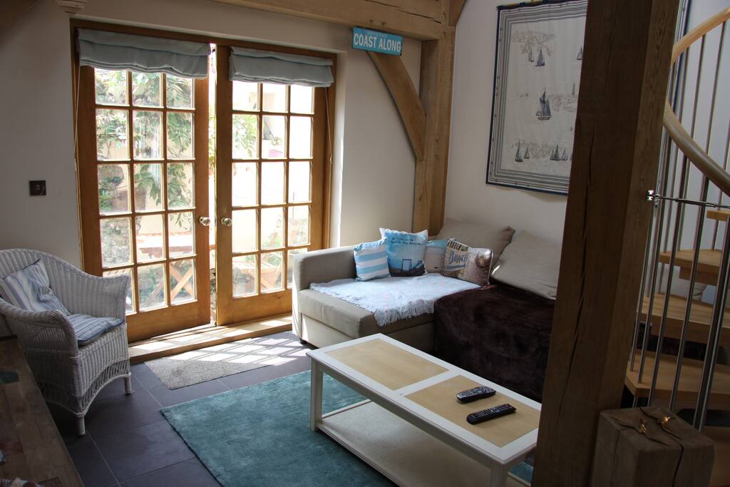 Lounge with doors to small patio area