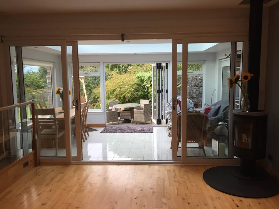 Conservatory with dining table and sofa and chairs