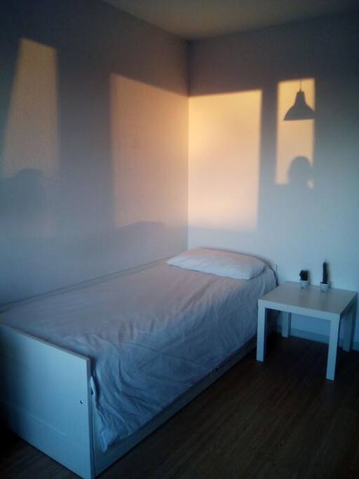 Gemütliche Ecke mit Bett und Nachttisch.