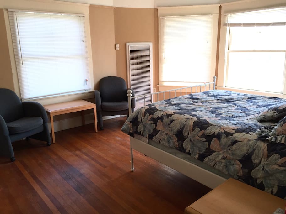 Master bedroom with queen size bed and lounging area (closet to the left)
