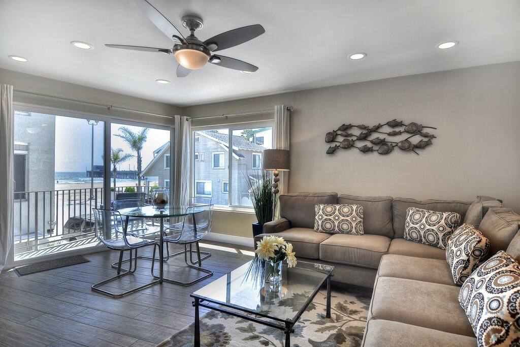 Living room is open and bright with glass doors onto balcony