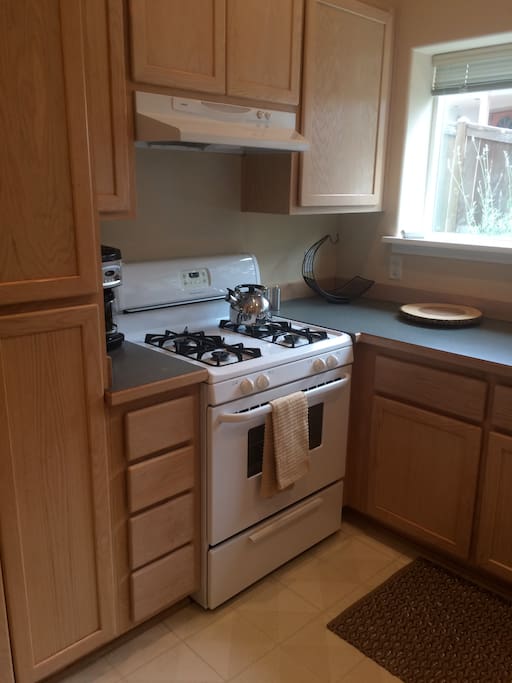 Fully stocked kitchen features gas range and dishwasher.
