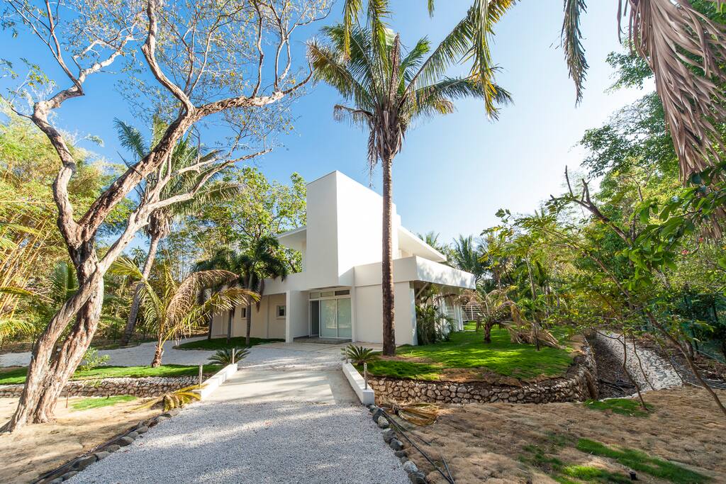 private & gated modern home with direct beach access