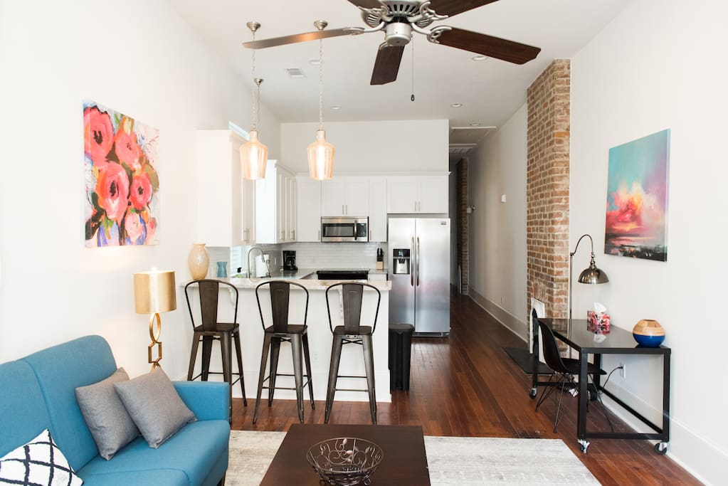 A brand new kitchen open to the living room with original hardwood floors and a desk in case you need to get some work done.