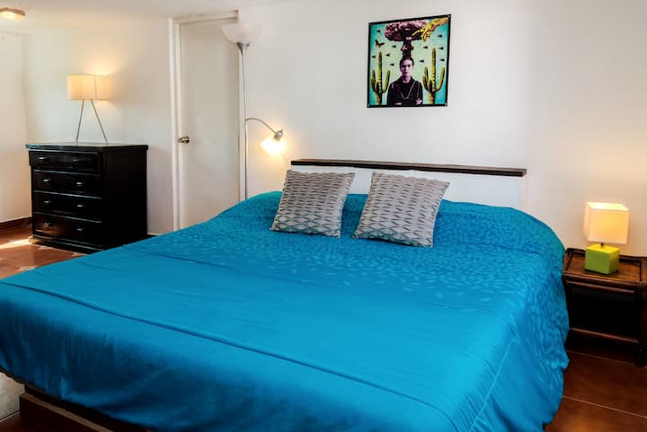 The bedroom is located on the top level of the penthouse. Through the door on the left you get to the full bathroom on the left and walk in closet on the right.