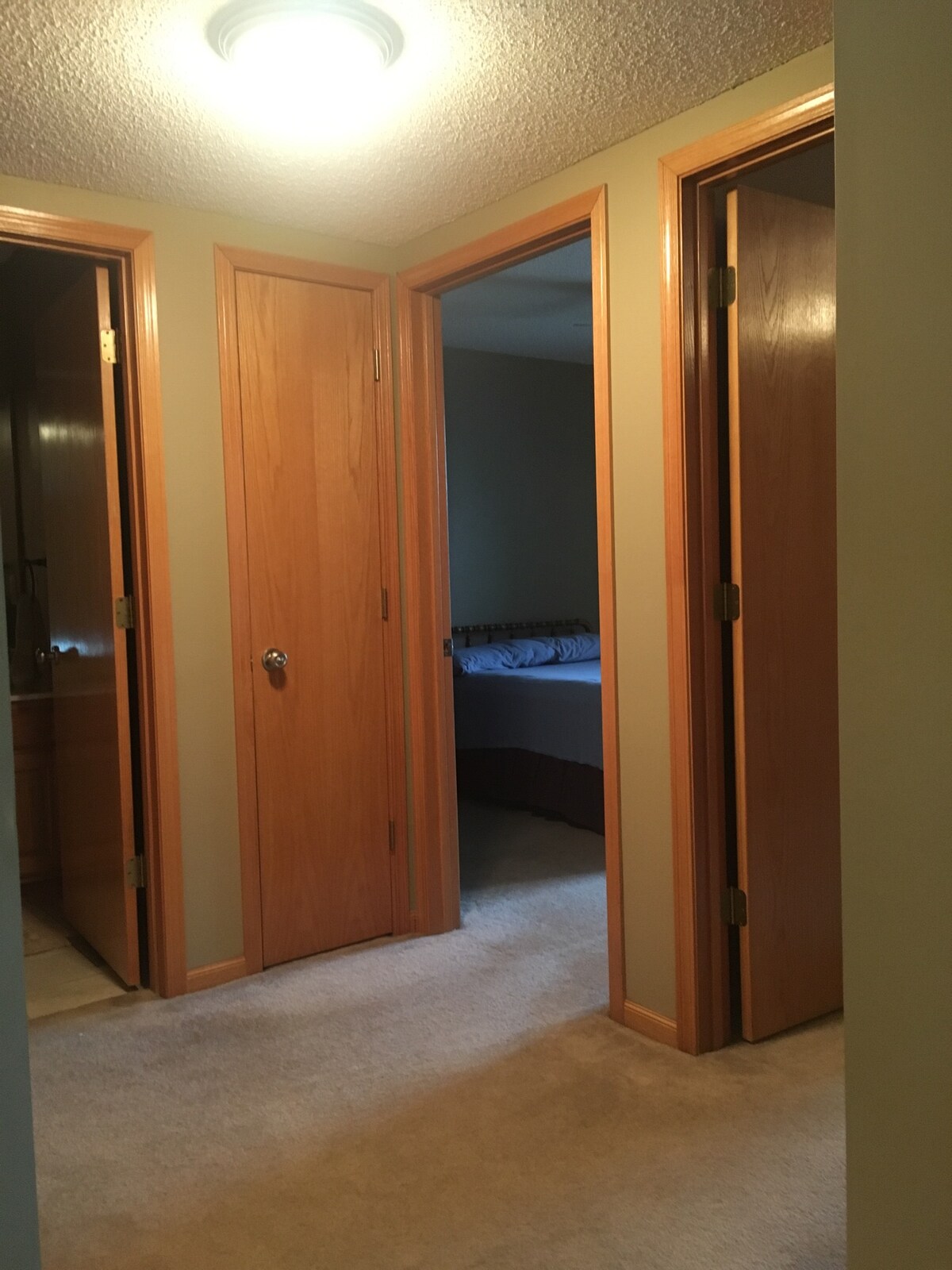 The upstairs landing and doors to the two rooms and bathroom 