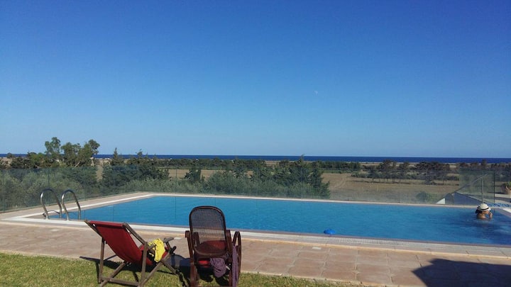 villa with a pool surrounded by nature