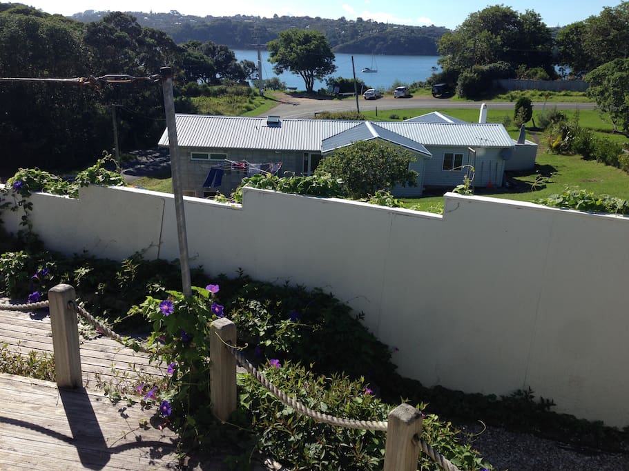 The view from the front deck- thats Oneroa Bay. The track down to the beach is by bench below the tree- 200m from the house