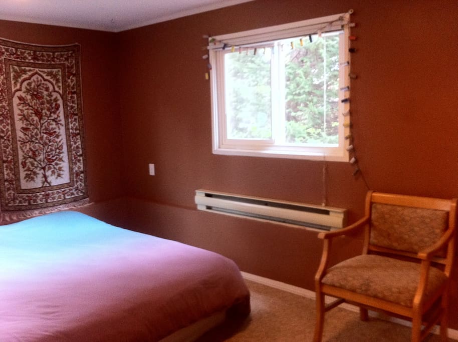 master bedroom with new queen bed overlooking the garden