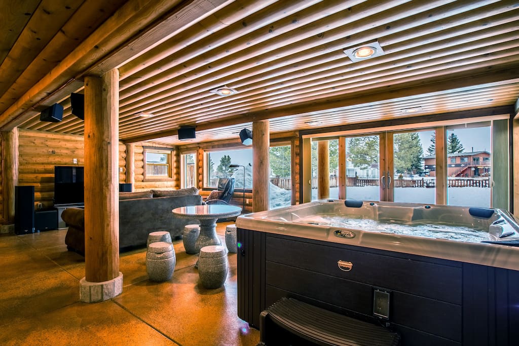 This bonus room has it all: indoor hot tub, marble game table, and HDTV with cable and sound system