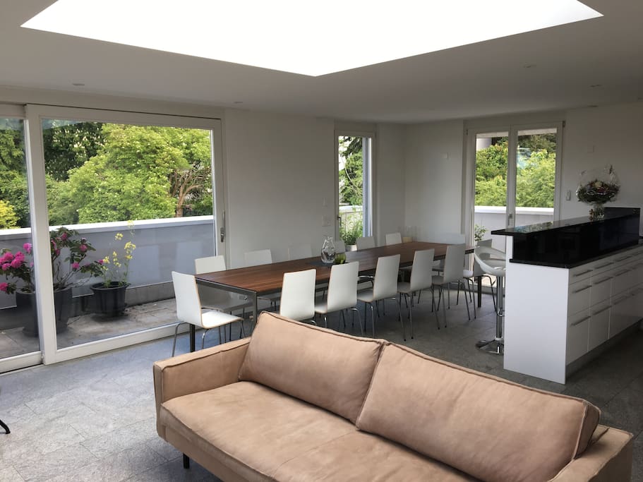 Huge living space on the top floor with big kitchen, sofa and table - open the big window slide doors and you feel like sitting outside.