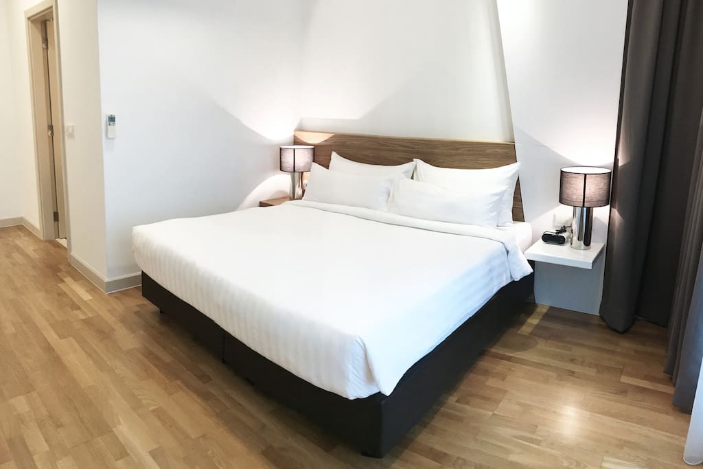 The master bedroom with a king sized bed & plush pillows.