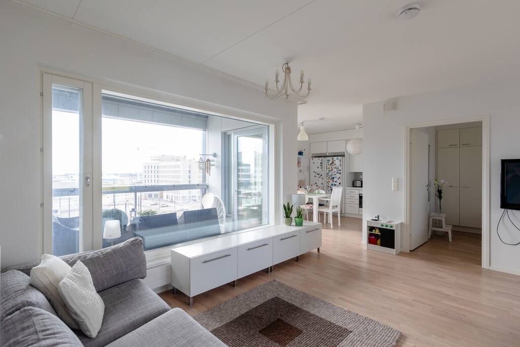 There are huge windows in the apartment bringing in lots of light and providing a panoramic view