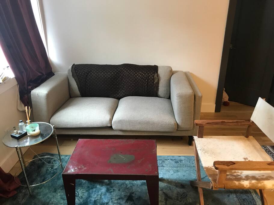 Living area with huge windows and deep couch. True living room