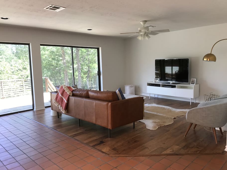 The living room faces large sliding glass doors to allow natural light and a beautiful view of the property.
