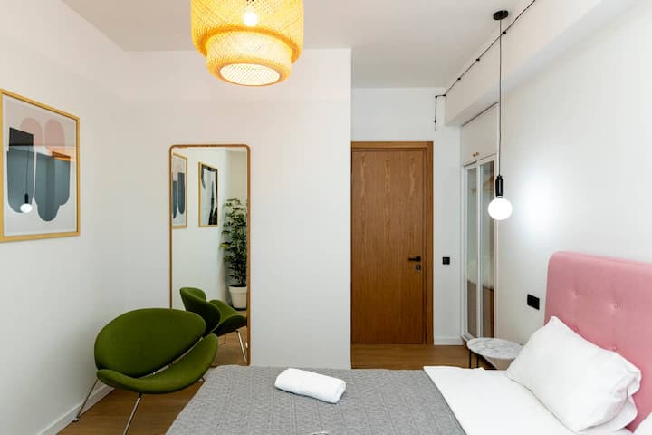 Beautiful wall decorations and a sleek mirror add a touch of elegance to this charming and well-designed bedroom