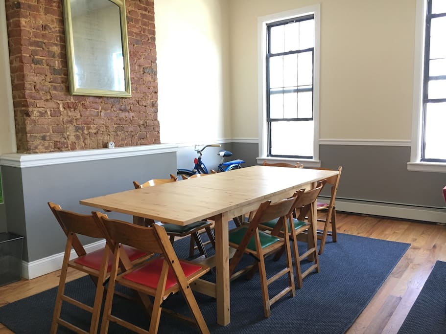 A large dining table that seats 8 people comfortably.