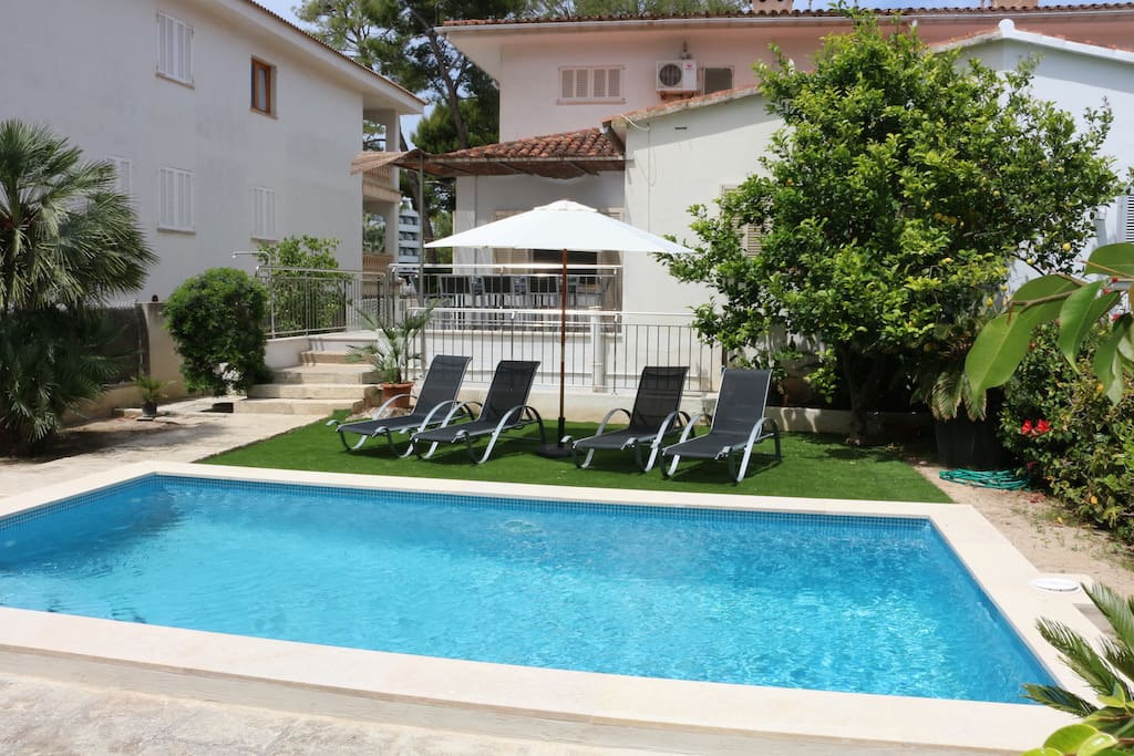 Private pool area with sun beds.