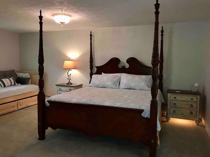 The multi-sectional King Room offers a king bed, a daybed with trundle (2 twin beds), and an ensuite double vanity bathroom. 
Each bedside table provides a usb charger and nightlight. Bring your own cords.