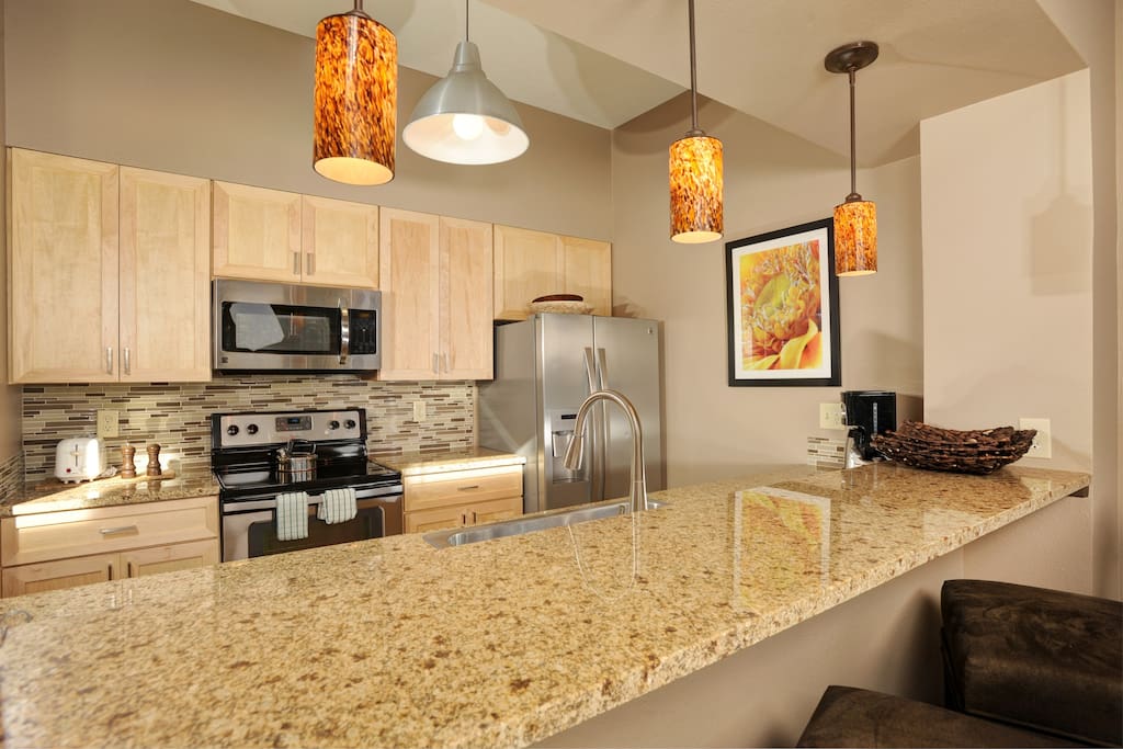 The fully-equipped kitchen features stainless steel appliances
