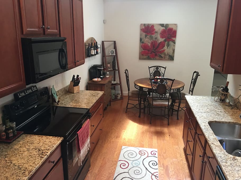 Well-appointed kitchen with granite countertops, microwave, dishwasher
