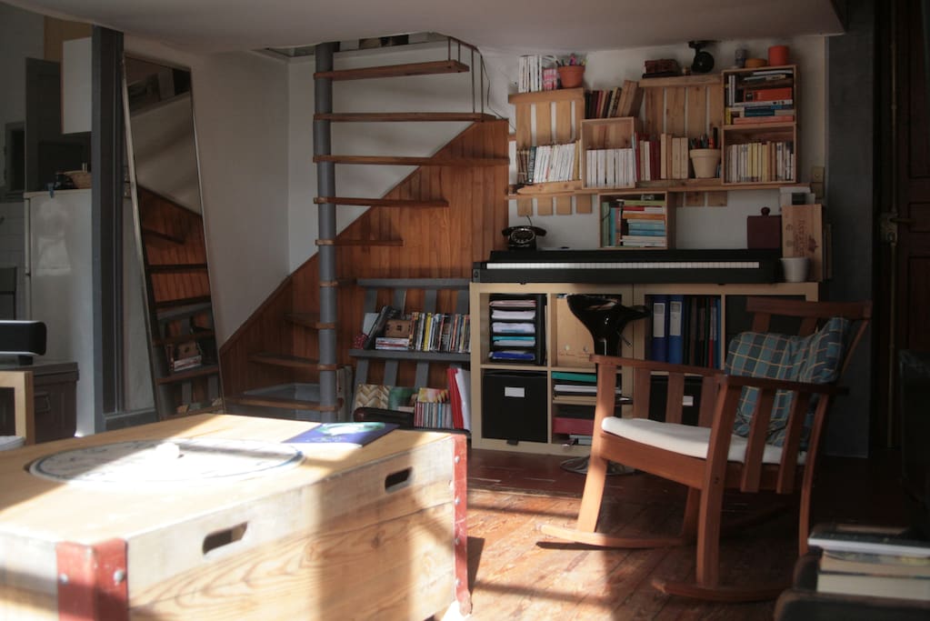 The stairs lead to a cozy mezzanine bedroom.