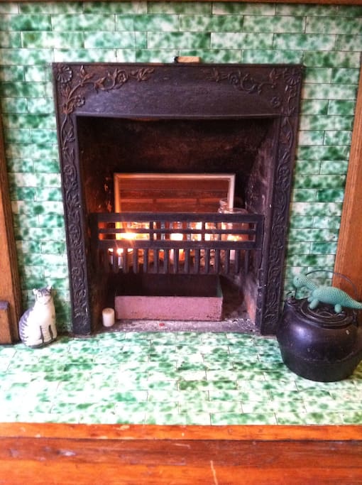 Decorative coal burning fireplace with original green subway tile.