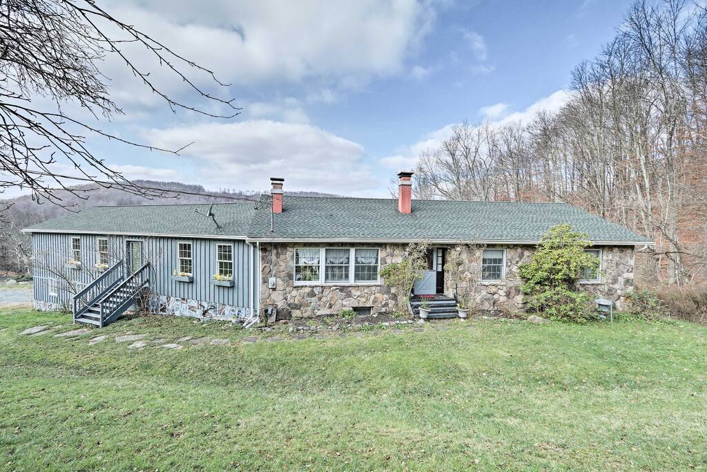 This charming abode is on 11 acres of scenic land with mountain and pond views!