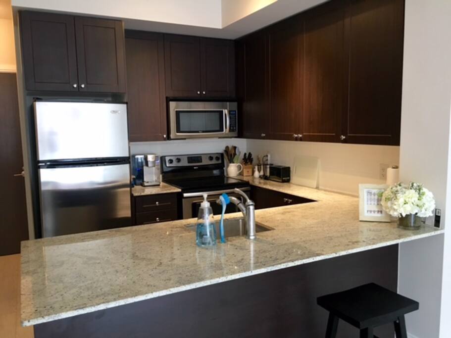 Fully equipped kitchen with stainless steel appliances, dishwasher and most essential items.