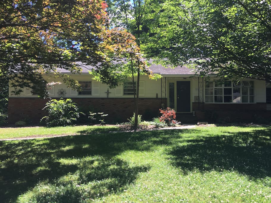 View from the street in the summer. The apartment entrance is around back.