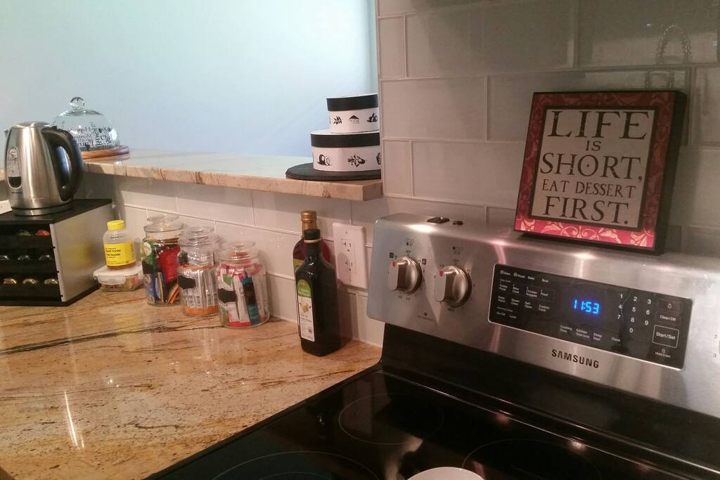 Kitchen has new appliances with coffee station.