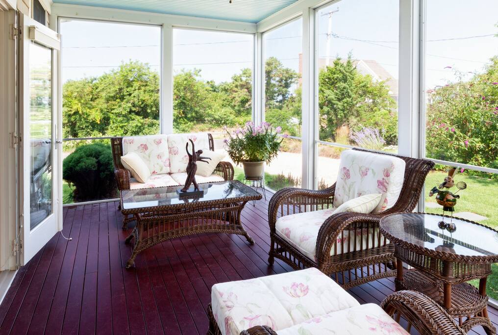The covered porch with comfortable seating makes a nice spot for morning coffee.