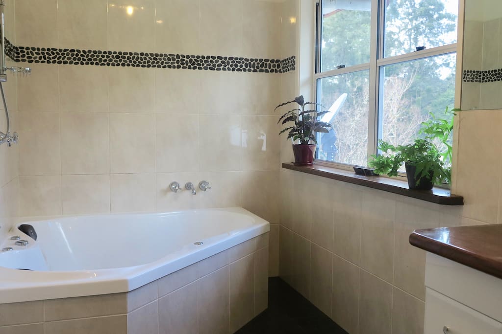 Ensuite bathroom with a bush view.