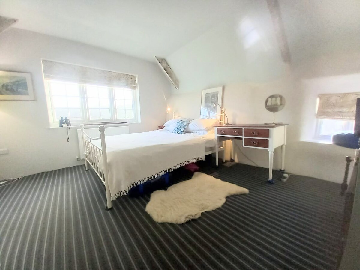 Riverside bedroom complete with desk, chair UHD monitor and multi-way power adaptor