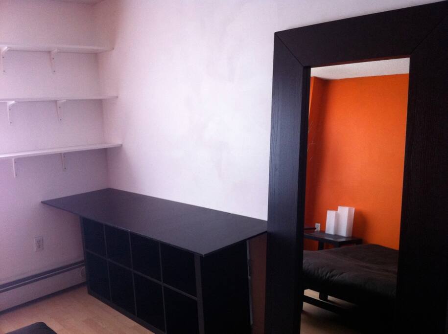 Plenty of storage under desktop as well as wall shelves